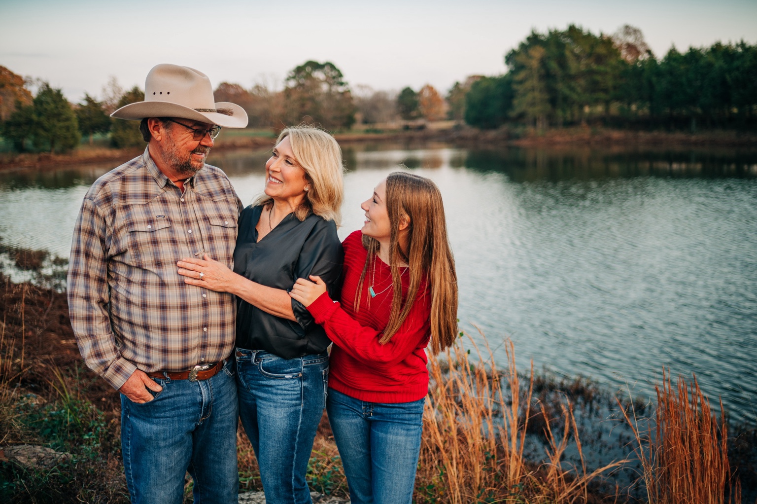 The Capps family sharing a moment beside the pond